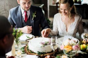 bride-and-groom-cutting-cake-on-wedding-reception