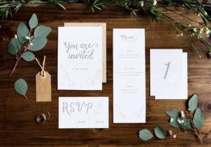 wedding-invitation-cards-papers-laying-on-table