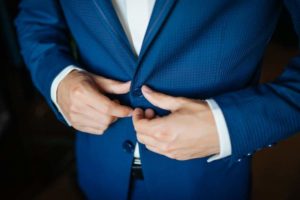 wedding-preparation-groom-buttoning-his-blue-jacket-before-wedding