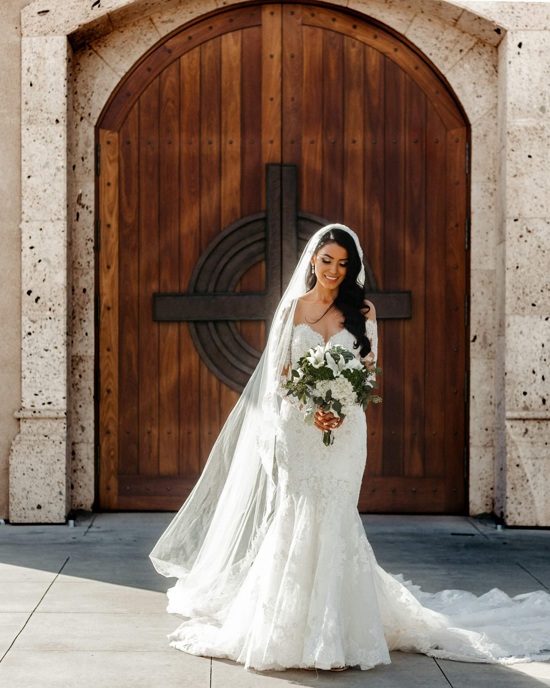 woman-wearing-wedding-dress-holding-bouquet-of-flowers